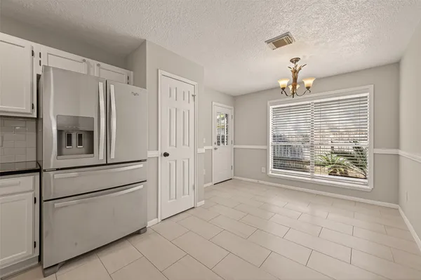 a view of a kitchen with an empty space and a window