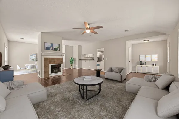 a living room with a couch a fireplace and a chandelier