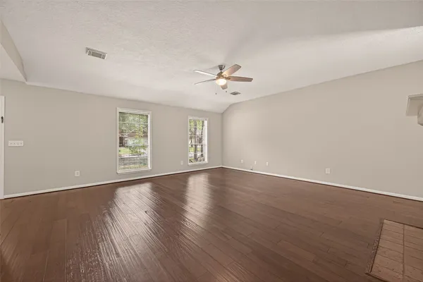 wooden floor in an empty room with a window