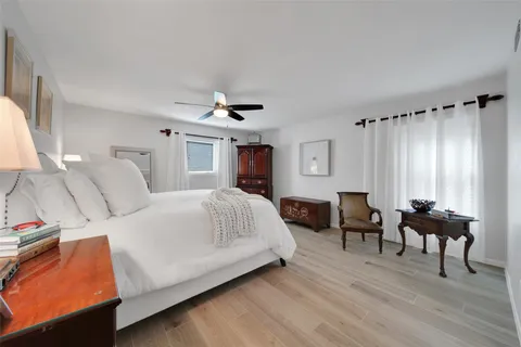 a bedroom with furniture and a wooden floor