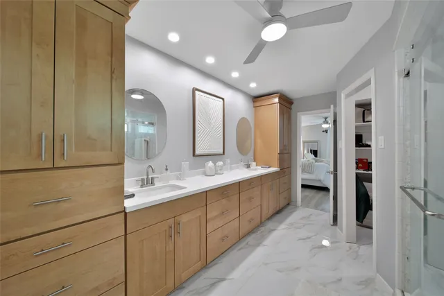 a spacious bathroom with a double vanity sink a and a mirror