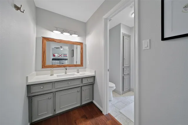 a bathroom with a toilet sink and mirror