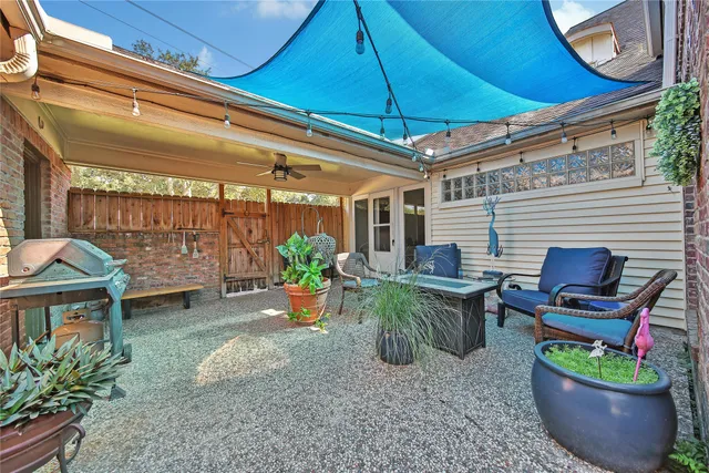 a view of a backyard with plants and a patio