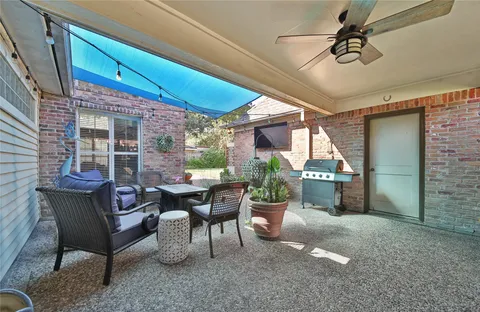 a view of a patio with table and chairs and potted plants