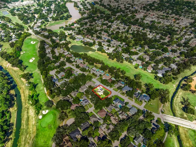 a view of swimming pool with a table and chairs and potted plants