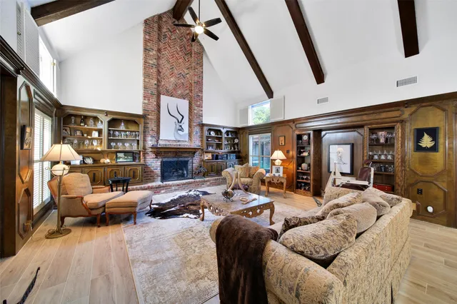 a living room with furniture fireplace and flat screen tv