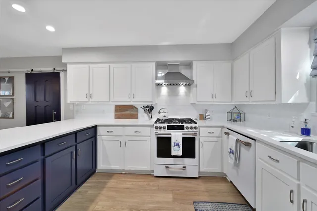 a kitchen with white cabinets stainless steel appliances and sink