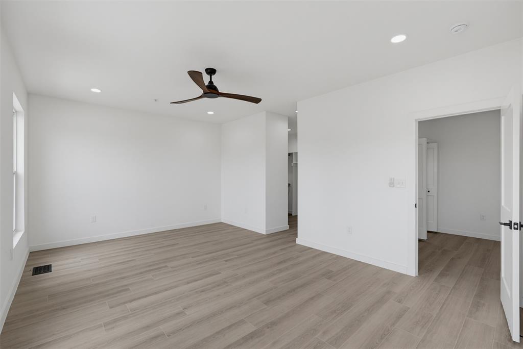 516 South O Connor Road Irving, TX 75060 - Photo 13 of 23 Spacious interior featuring wood-finish flooring, a modern ceiling fan, recessed lighting, and white trim