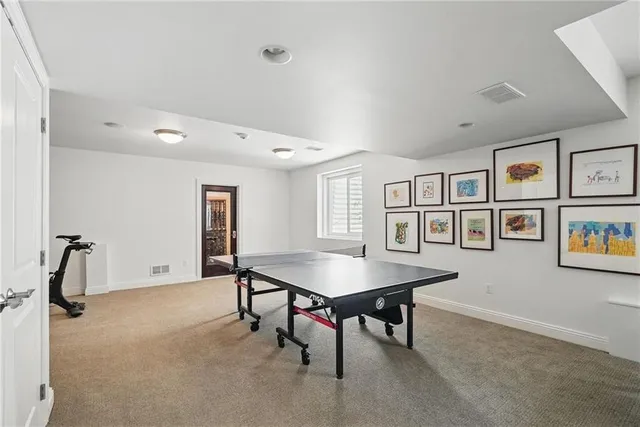 a room with furniture pool table and windows