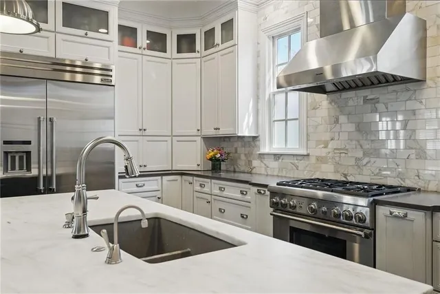a kitchen with granite countertop a stove and a sink