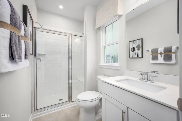 a spacious bedroom with a bed and a window