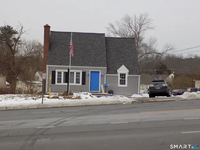 a front view of a house with a road