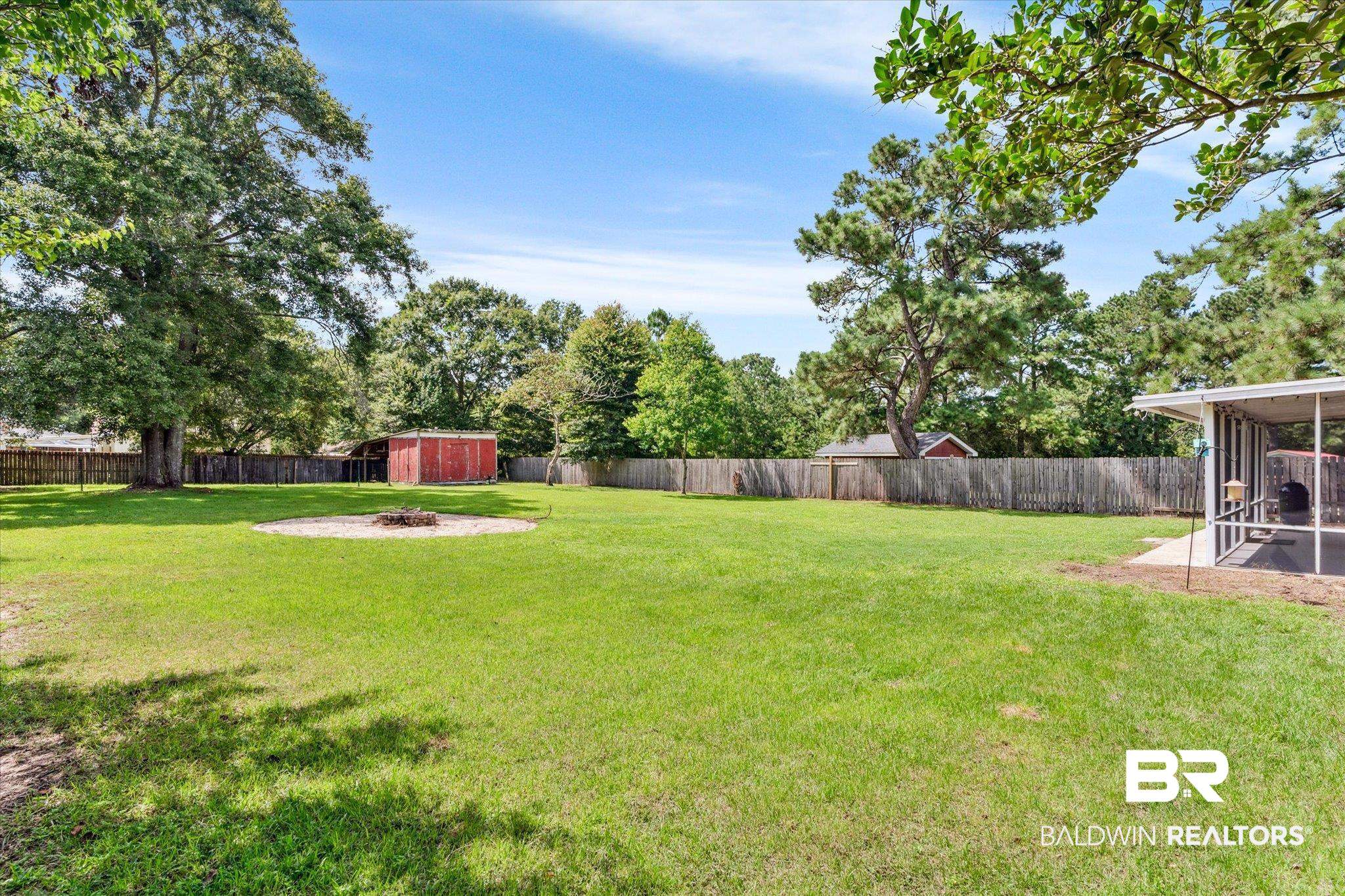 9306 Prairie Drive Semmes, AL 36575 - Photo 16 of 20 View of yard with a storage unit, a patio area, and a sunroom