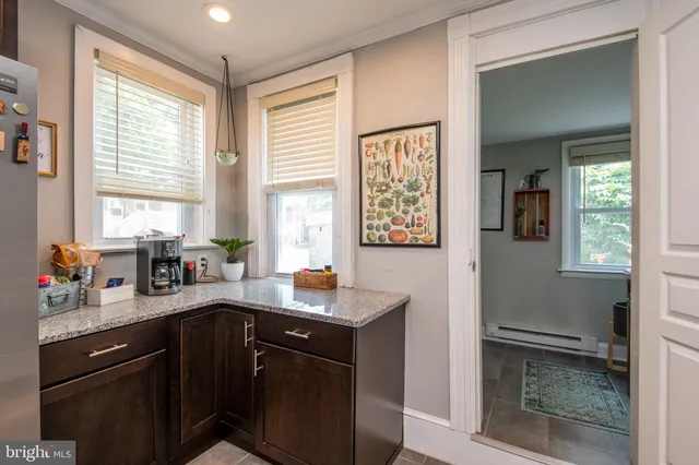 a bathroom with a sink a toilet and a window