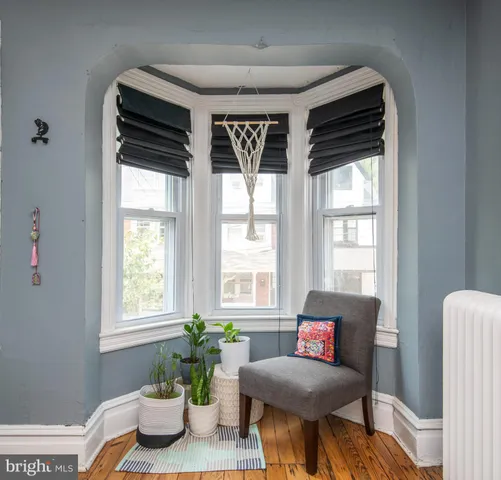 a spacious bedroom with a bed and large windows