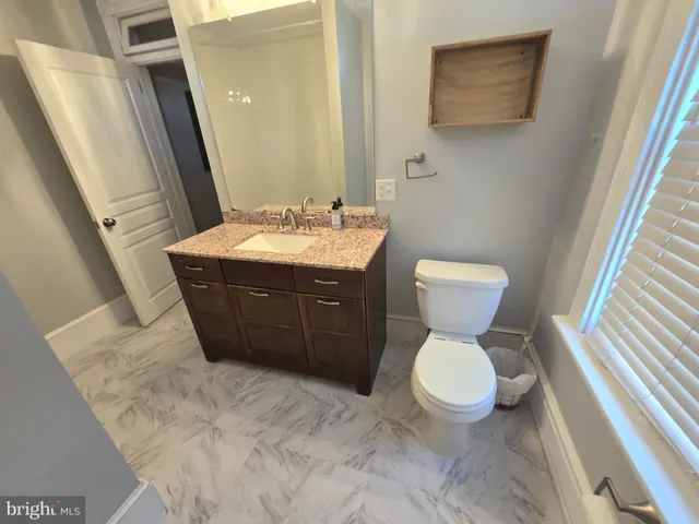 a view of a chair and table in the balcony