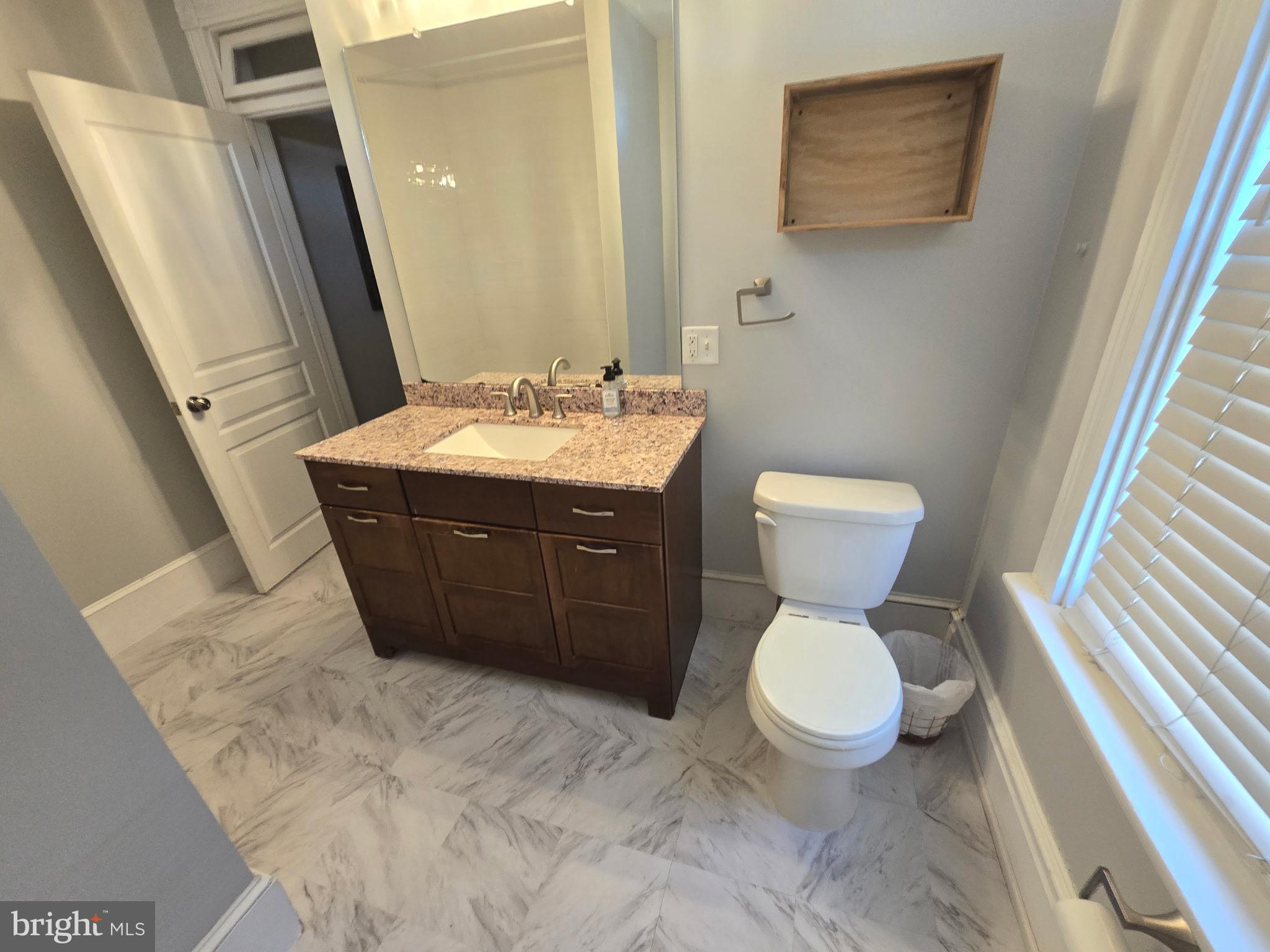 445 Nevin Street Lancaster, PA 17603 - Photo 25 of 53 a bathroom with a toilet sink and mirror