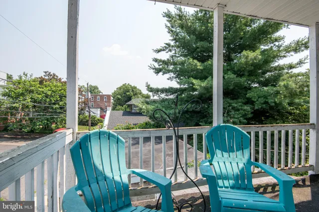 a bedroom with furniture and a wooden floor