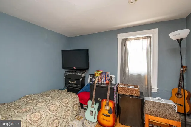 a bedroom with a bed and a chair