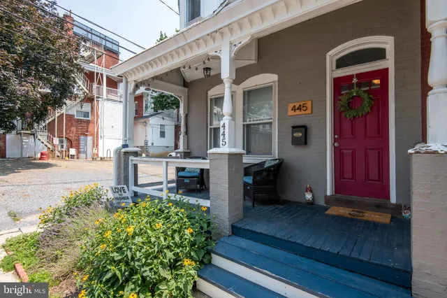 a view of a house with wooden fence