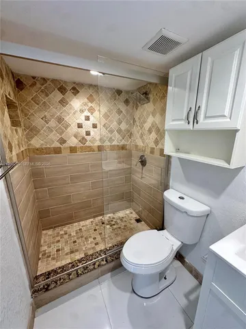 a bathroom with a toilet and shower