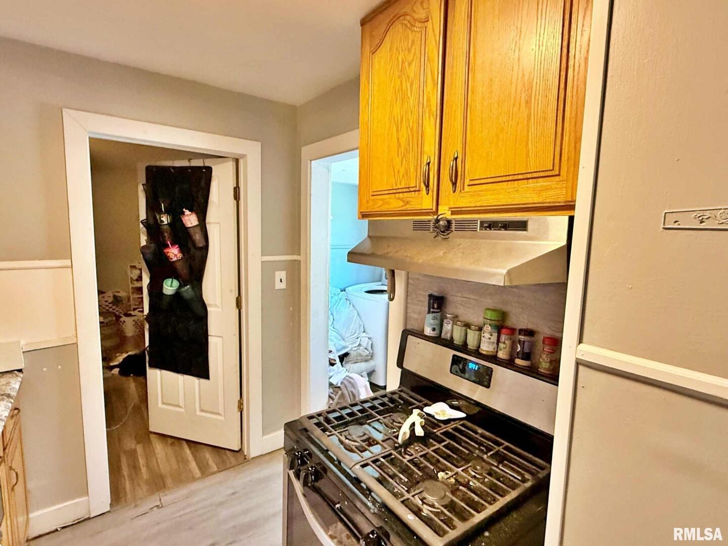 1603 Ferry Street Metropolis, IL 62960 - Photo 19 of 26 a kitchen with stainless steel appliances granite countertop a refrigerator and a stove
