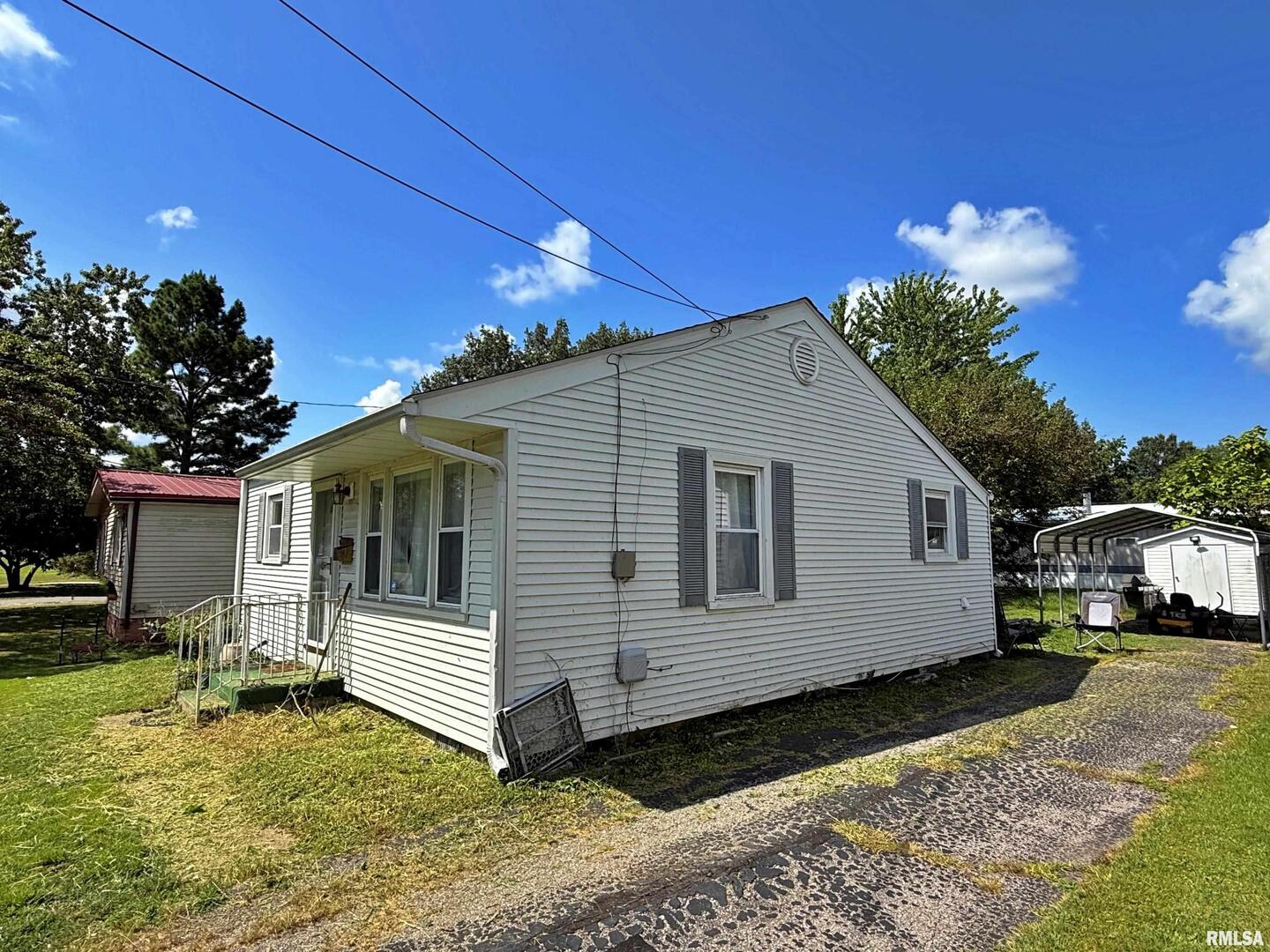 1603 Ferry Street Metropolis, IL 62960 - Photo 5 of 26 a view of a white house with a yard