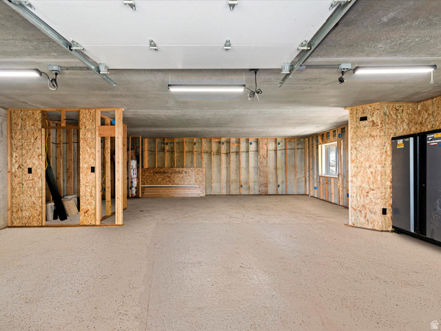 1225 Old Oregon Road Soda Springs, ID 83276 - Photo 53 of 67 Spacious garage with exposed wood framing, concrete flooring, and multiple overhead light fixtures