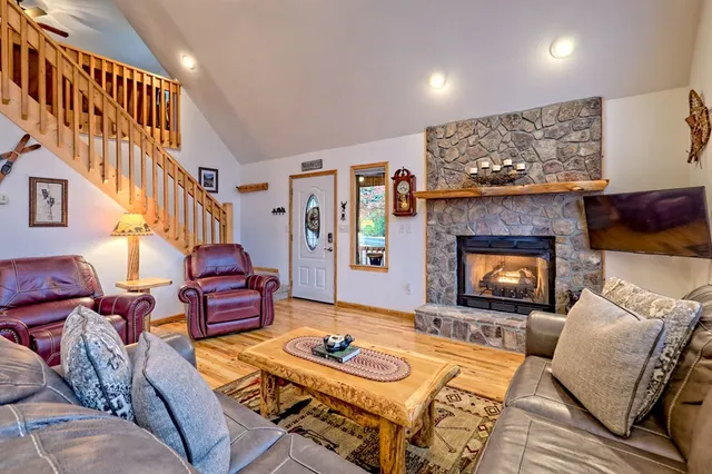 a living room with furniture ceiling fan and a window