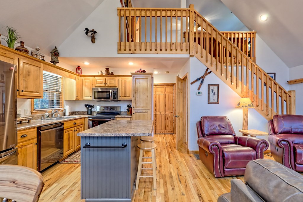 36 Prairie Crossing Murphy, NC 28906 - Photo 19 of 71 a kitchen with stainless steel appliances kitchen island granite countertop a refrigerator a stove a sink and a dining table with wooden floor
