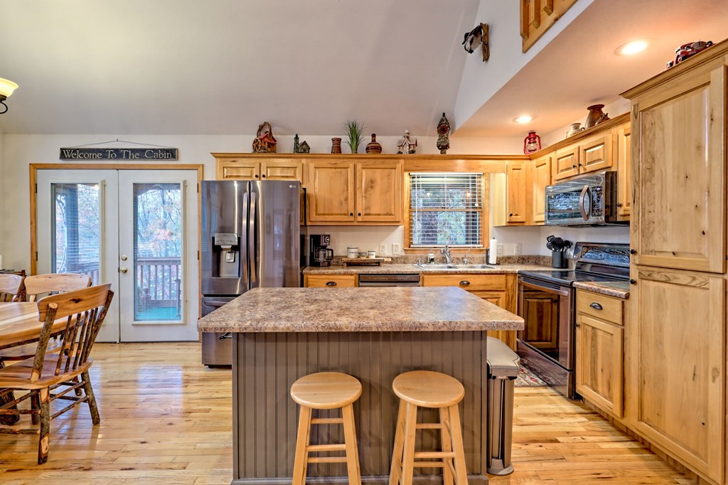 36 Prairie Crossing Murphy, NC 28906 - Photo 21 of 71 a kitchen with stainless steel appliances granite countertop a stove top oven a sink a dining table and chairs