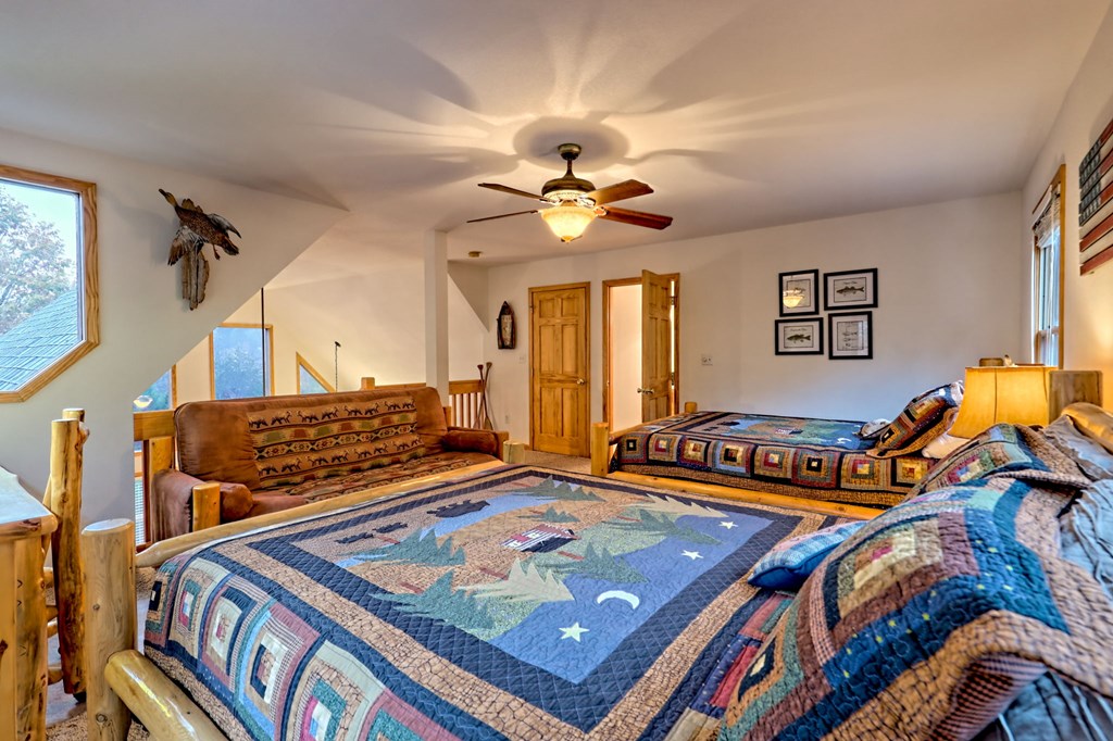 36 Prairie Crossing Murphy, NC 28906 - Photo 29 of 71 a living room with blue floor to ceiling windows and a chandelier