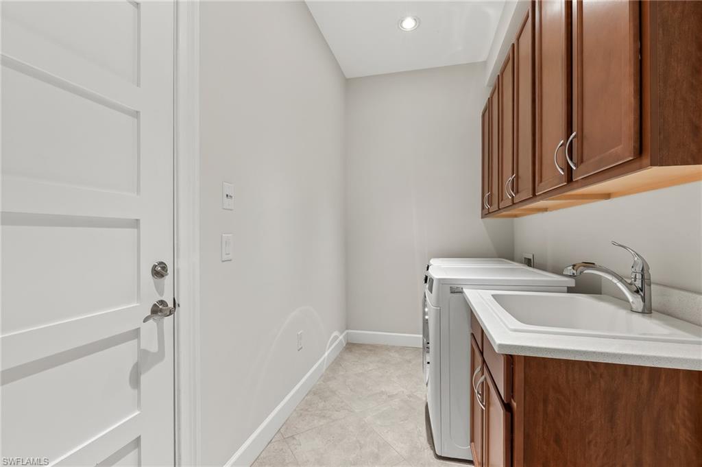 6939 Cay Court Naples, FL 34113 - Photo 18 of 31 Laundry room featuring cabinet space, recessed lighting, and washer and dryer