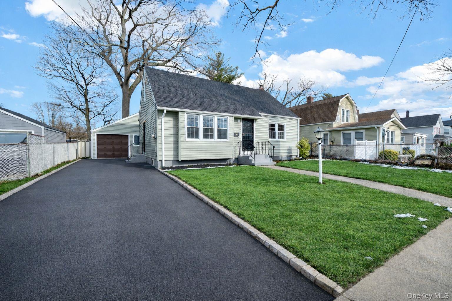 Front exterior with private driveway and one-car garage