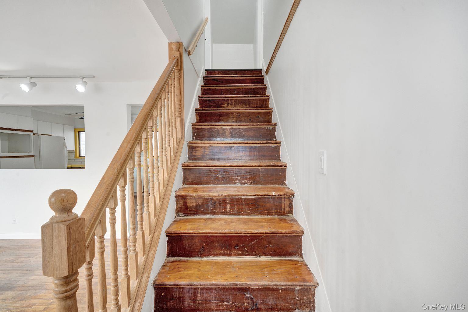 450 Rhodes Lane West Hempstead, NY 11552 - Photo 12 of 16 Interior staircase connecting main and upper levels.