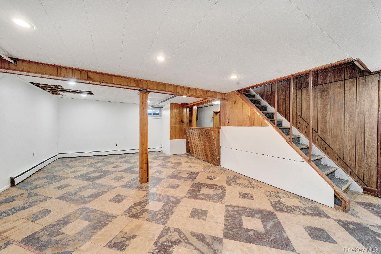 450 Rhodes Lane West Hempstead, NY 11552 - Photo 13 of 16 Finished basement offering open recreational space bar area and flexibility of use.