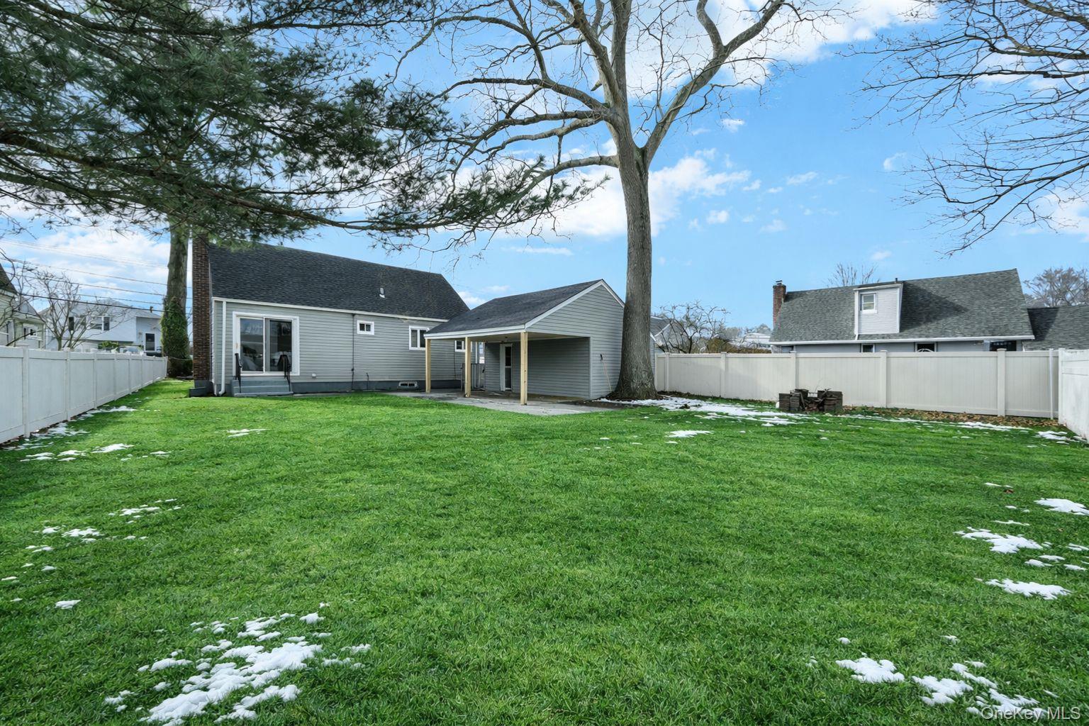 450 Rhodes Lane West Hempstead, NY 11552 - Photo 3 of 16 Spacious rear yard offering open space and flexibility for outdoor use.