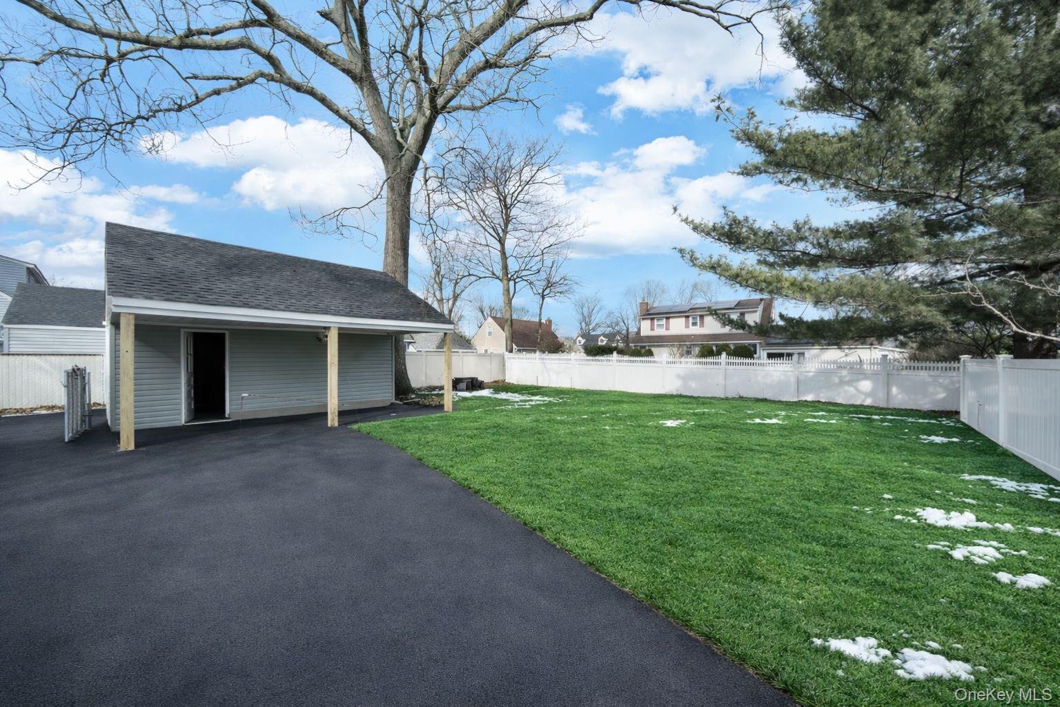450 Rhodes Lane West Hempstead, NY 11552 - Photo 4 of 16 Rear view showing garage access, backyard area and covered pavilion.