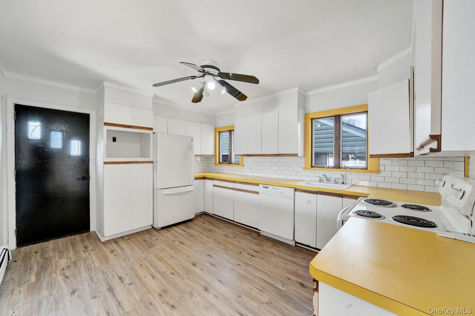 450 Rhodes Lane West Hempstead, NY 11552 - Photo 8 of 16 Kitchen with ample cabinetry, counter space, and adjacent acccess to main living area.
