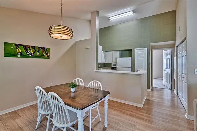 a view of a dining room with furniture wooden floor and chandelier