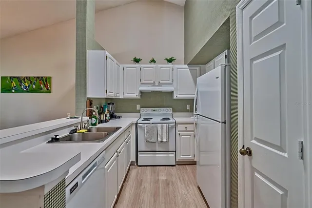 a kitchen with a sink stove and refrigerator