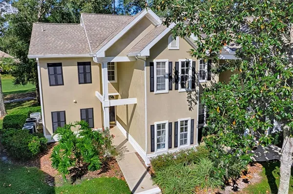a aerial view of a house with a yard and potted plants