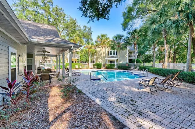 a view of a house with backyard porch and sitting area