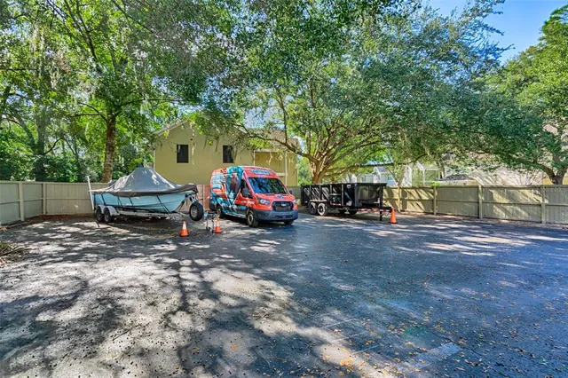 a view of a house with truck parked on a road