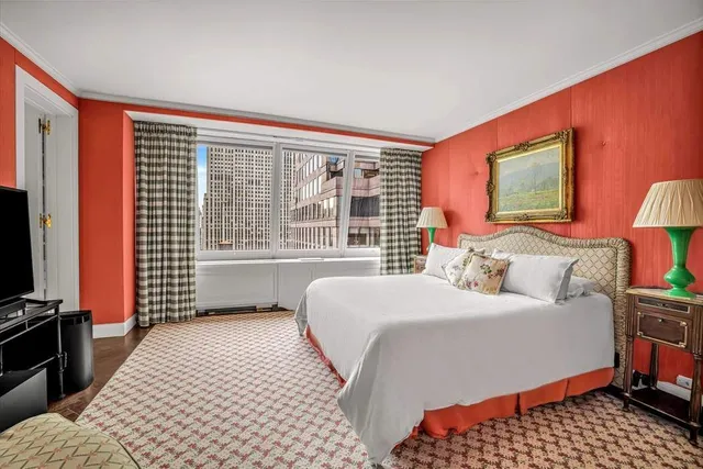 a bedroom with two beds and a flat screen tv