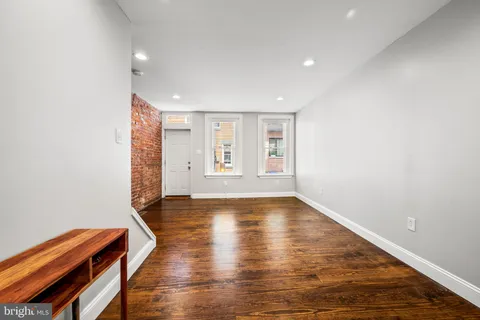 a view of a room with wooden floor and windows