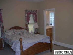 7301 Nesbit Road Waxhaw, NC 28173 - Photo 2 of 8 a bedroom with a bed and a lamp on table