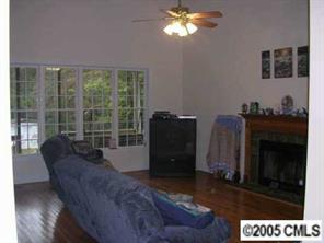 7301 Nesbit Road Waxhaw, NC 28173 - Photo 8 of 8 a living room with furniture and a fireplace