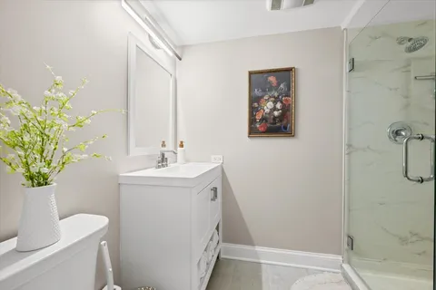 a bathroom with a sink a toilet and a mirror