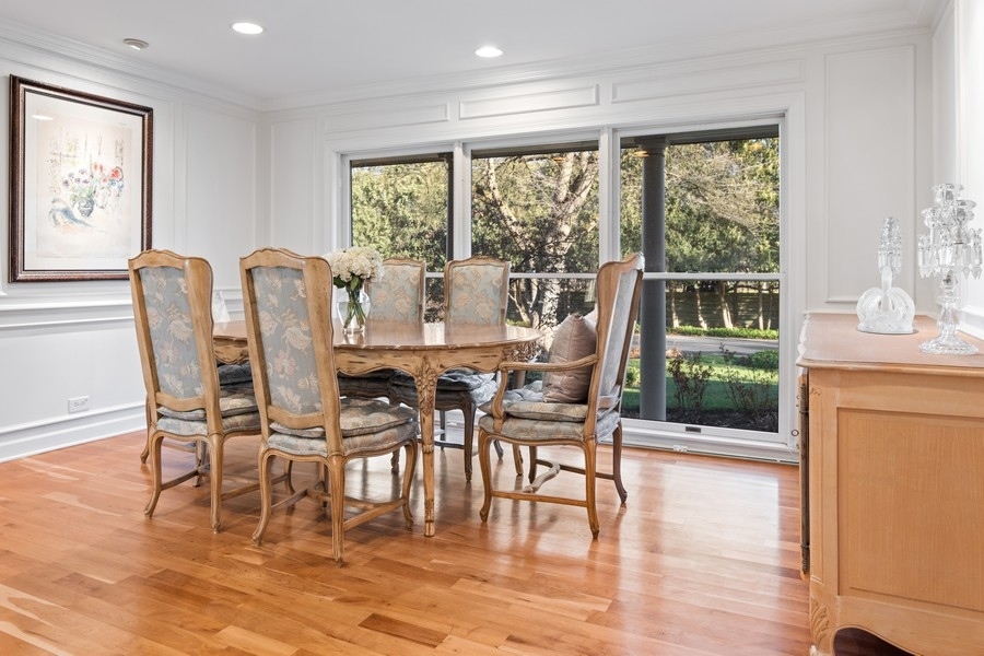 48 Meadowview Road Northfield, IL 60093 - Photo 25 of 42 a dining room with wooden floor a glass table and chairs